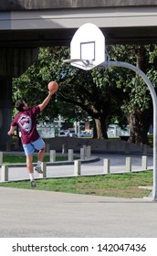 AUCKLAND, NZ - MAY 27: :Young Man Plays Basketball In Victoria Park On May 27 2013.Basketball Is One Of The Most Popular Sports In The World.