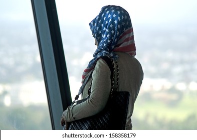 AUCKLAND - OCT 08 2013:Adult arab muslim woman wearing hijab made out from the American flag visit Sky Tower.Muslim religion in NZ growing, It's estimated that there are approximately 17,000 Muslims.