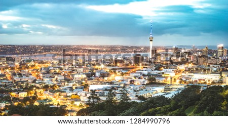Auckland skyline from Mount Eden after sunset during blue hour - New Zealand modern city with spectacular nightscape panorama -  Enhanced filter on night lights