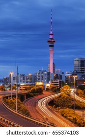 Auckland At Twilight, With Car Trails Illuminated On Motorway.