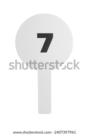 Auction paddle with number 7 isolated on white