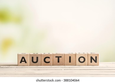 Auction sign on a vintage table on green background - Shutterstock ID 388104064