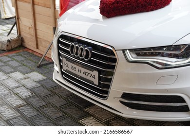 Audi decorated with flowers in indian wedding celebration. People present. - Goa India May 2022