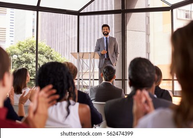 Audience applauding speaker at a business seminar