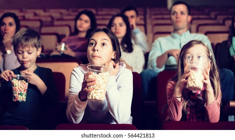 Audience attending movie night with popcorn in cinema house - Powered by Shutterstock