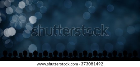Audience and blue bokeh background with wide banner composition. Background for business and marketing presentations (ideal for target audience, target customer, mass marketing etc.).
