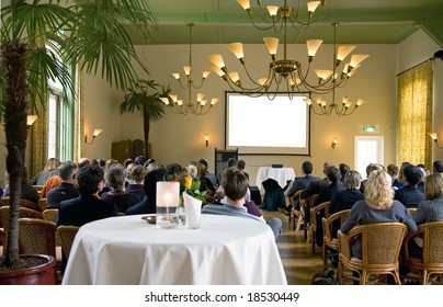audience at a conference in a classical surrounding
