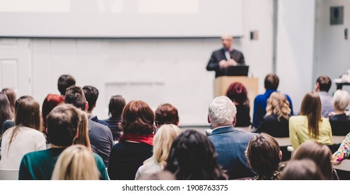 Audience At The Conference Hall. Speaker Giving A Talk On Corporate Business Conference. Business And Entrepreneurship Event.