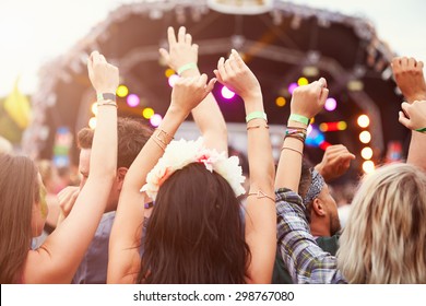 Audience with hands in the air at a music festival