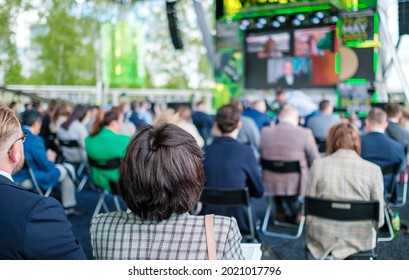 Audience Listening To Speaker On Screen During International Technology Conference