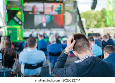 Audience Listening To Speaker On Screen During International Technology Conference