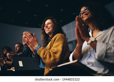 Audience listening to the speech and clapping hands. Group of business people attending a convention applauding during the forum. - Shutterstock ID 1944831523