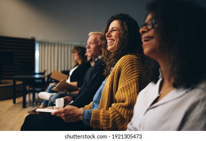 Audience listening to the speech of the speaker and smiling. Group of business people attending a convention. - Shutterstock ID 1921305473