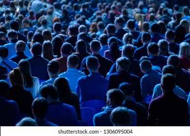 Audience listens to the lecturer at the business conference, back view, blue tones - Shutterstock ID 1306095004