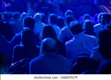 Audience Listens To The Lecturer At The Business Conference, Back View, Blue Tones