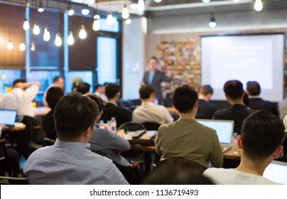 Audience Listens to Lecturer at a Conference Meeting Seminar Training. Group of People Hear Presenter Give Speech . Corporate Manager Speaker Gives Business Technology and Economic Forecast. - Shutterstock ID 1136719493