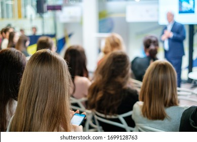 Audience listens lecturer at workshop in conference hall - Shutterstock ID 1699128763
