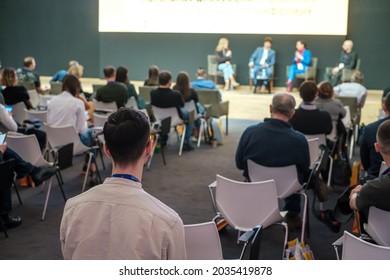Audience listens to panel discussion at conference hall, rear view - Shutterstock ID 2035419878