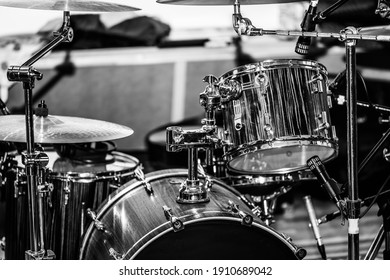 An audience side view of a drum kit set up for recording in a recording studio with microphones in place