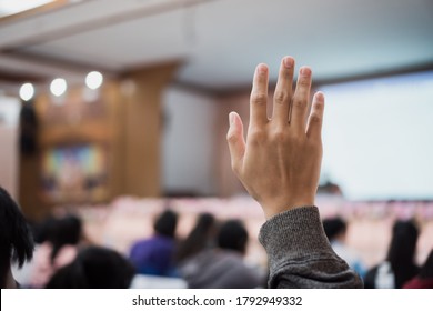 Audience Or Students Raising Hands Up At Conference To Answer Question While Speaker Speech At Seminar Hall With Crowd Groups, Arms Of Large Group In Classroom For Vote Or Questions