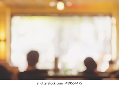 Audience in a theater, on a concert and applauding blurred, people sitting in a restaurant or cafe, unrecognizable blurry silhouettes with space for text - Powered by Shutterstock