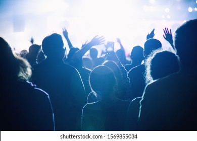 The Audience Watching The Concert On Stage. Silhouette Of A Crowd Of Having Fun Fans.