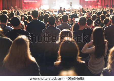 The audience watching the concert on stage.
