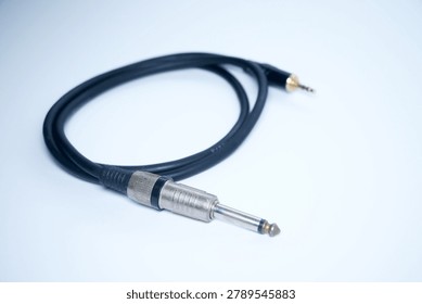 Audio cable with a jack and plug on light background.