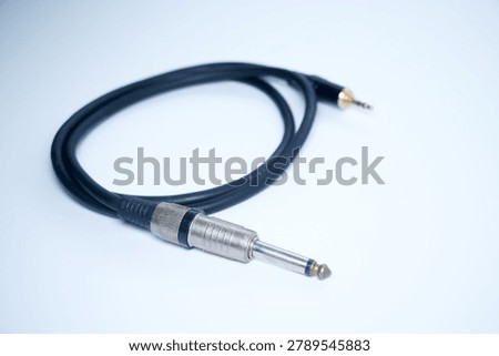 Audio cable with a jack and plug on light background.
