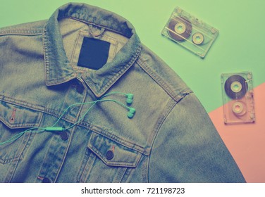 Audio Cassettes, Headphones And Jeans Jacket On A Blue Pink Creamy Background. Entertainment And Fashion 80s.