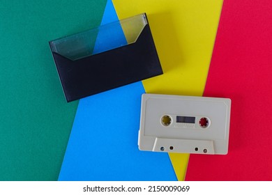 Audio Cassettes On A Multi-colored Paper Background. Music Tape Entertainment 80s, Retro Media Technology 90s. Nostalgia Music Concept.