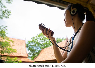 Audio Guide Learning History. Asian Woman Listening Landmark Of Local Area For Study With Guide Radio MP3.