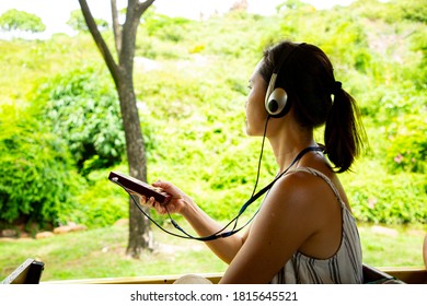 Audio Guide Learning History. Asian Woman Listening Landmark Of Local Area For Study With Guide Radio MP3.