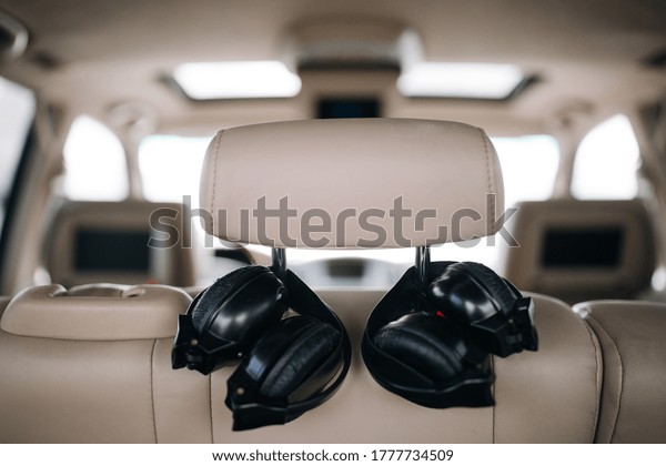 Audio\
headphones at the rear seat row of luxury\
car