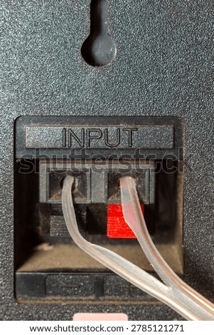 Audio input cables connected to the back panel of professional sound equipment