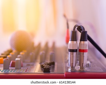 Audio jack cable connected on music mixer.