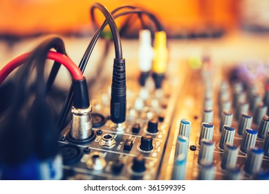 audio jack and wires connected to audio mixer, music dj equipment at concert, festival, bar