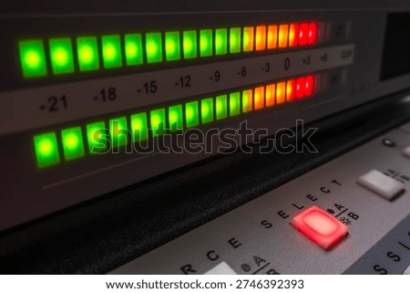 Audio level meter with illuminated source button