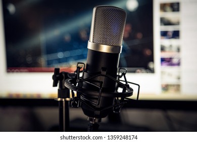Audio recording vocal studio voice microphone with anti shock mount and built in anti pop filter for singing and voiceover actors doing voiceovers.