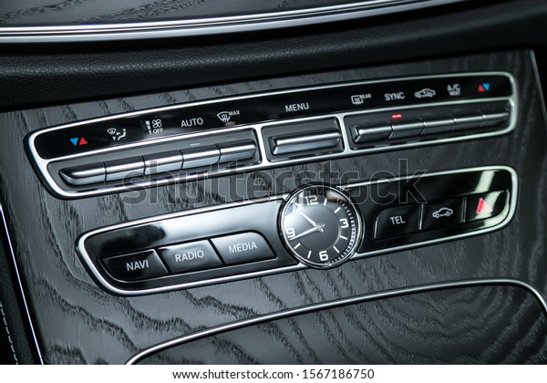 Audio stereo\
system, control panel and cd in a modern car. Car control panel of\
audio player and other devices\
.A shallow depth of field close up\
of the control panel of a car.\
\

