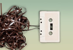 Audio tape cassette., a pile of brown tape next to a white cassette, a Technology Photo by Billion Photos
