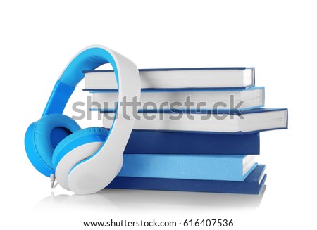 Audiobook concept. Stack of books and headphones on white background