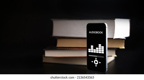 Audiobook Education. Smartphone Screen With Audiobook Application On Paper Books Black Background. Ebook E Learning Electronic Internet Mobility Concept