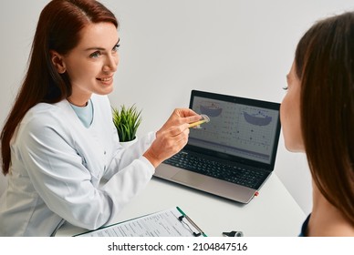 Audiologist advising patient to use BTE hearing aids to treat her deafness during consultation at hearing clinic. Audiology, hearing solutions