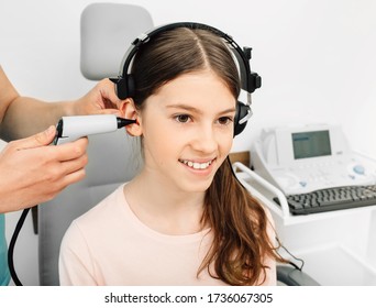 Audiologist Is Doing A Hearing Exam On A Girl. Impedance Audiometry. Methods For Testing The Middle Ear In A Child