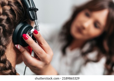 Audiologist Doing Impedance Audiometry Or Diagnosis Of Hearing Impairment. An Beautiful Teenage Girl Getting An Auditory Test At A Hearing Clinic. Healthcare And Medicine Concept. Close Up Shot.