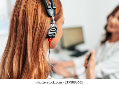 Audiologist Doing Impedance Audiometry Or Diagnosis Of Hearing Impairment. An Beautiful Redhead Adult Woman Getting An Auditory Test At A Hearing Clinic. Close Up Shot.