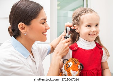 Audiologist Examining Little Patient With Otoscope, Hearing Exam Of Child