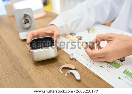 Audiologist explaining hearing aid technology to a patient
