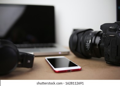 audiovisual production office with camera headphones mobile phone laptop computer photographic and audio equipment - Powered by Shutterstock
